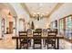 Bright dining room featuring stone columns, travertine floors, and view into adjacent living spaces at 1523 N 103Rd St, Mesa, AZ 85207