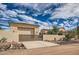 Exterior of desert home with tile roof, desert landscaping, and gated driveway entrance at 1523 N 103Rd St, Mesa, AZ 85207