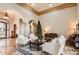 Grand living room featuring stone columns, tile floors, and an open layout perfect for entertaining at 1523 N 103Rd St, Mesa, AZ 85207