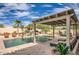 Backyard swimming pool featuring a covered patio, landscaping, and patio furniture at 1523 N 103Rd St, Mesa, AZ 85207