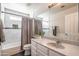 Bright bathroom with modern vanity and tub featuring decorative tile accents at 1550 E Park Ave, Gilbert, AZ 85234