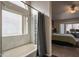 Bright bathroom with shower and tub combination; access to the main bedroom at 1550 E Park Ave, Gilbert, AZ 85234