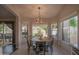 Bright dining area features a circular table, backyard views, and a modern light fixture at 1550 E Park Ave, Gilbert, AZ 85234