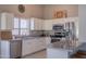 Bright kitchen featuring white cabinets, stainless steel appliances, and a stylish breakfast bar at 1550 E Park Ave, Gilbert, AZ 85234