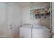 Bright laundry room with white appliances, white shelves, and ample storage space at 1550 E Park Ave, Gilbert, AZ 85234