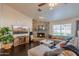 Cozy living room with a stone fireplace, hardwood floors, and a comfortable sectional sofa at 1550 E Park Ave, Gilbert, AZ 85234