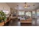 Warm living room featuring hardwood floors, stone fireplace, and a comfortable sectional sofa at 1550 E Park Ave, Gilbert, AZ 85234