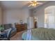 Large main bedroom with ceiling fan, archway entrance, and comfy chair at 1550 E Park Ave, Gilbert, AZ 85234