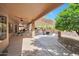 Expansive backyard patio with multiple seating areas, outdoor kitchen, and desert landscaping at 16131 W Indianola Ave, Goodyear, AZ 85395