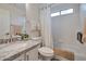 Cozy bathroom with tub and shower combo with white subway tile, a decorative shower curtain and granite vanity at 16131 W Indianola Ave, Goodyear, AZ 85395