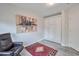 Comfortable bedroom showcasing a stylish murphy bed, elegant flooring, and decorative rug at 16131 W Indianola Ave, Goodyear, AZ 85395