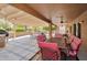 Spacious covered patio with ceiling fans and ample seating, ideal for relaxation and gatherings at 16131 W Indianola Ave, Goodyear, AZ 85395