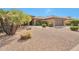 Desert landscaped home exterior featuring a large driveway leading to the attached garage at 16131 W Indianola Ave, Goodyear, AZ 85395