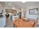 Open kitchen and dining area with stainless steel appliances, granite countertops, and wood-look tile flooring at 16131 W Indianola Ave, Goodyear, AZ 85395