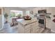 Modern kitchen featuring stainless steel appliances, granite countertops, and adjacent dining space at 16131 W Indianola Ave, Goodyear, AZ 85395