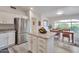 Bright kitchen with stainless steel appliances, granite countertops, and a cozy dining area at 16131 W Indianola Ave, Goodyear, AZ 85395