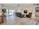 Bright living room with sliding glass doors to the patio and stylish wood-look tile flooring at 16131 W Indianola Ave, Goodyear, AZ 85395
