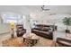 Spacious living room with vaulted ceilings, modern ceiling fan, and comfortable leather seating at 16131 W Indianola Ave, Goodyear, AZ 85395