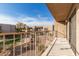 Private balcony overlooking the community landscaping with a railing, and a storage unit door at 16616 E Palisades Blvd # 109, Fountain Hills, AZ 85268