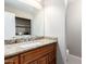 Powder room featuring a granite counter and vanity, with mirror and light fixtures at 16616 E Palisades Blvd # 109, Fountain Hills, AZ 85268