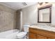 Bright bathroom features a shower-tub combo and a granite countertop vanity with a framed mirror at 16616 E Palisades Blvd # 109, Fountain Hills, AZ 85268