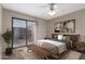 Cozy bedroom with a sliding door to a balcony, complemented by a sleek bed frame and modern art at 16616 E Palisades Blvd # 109, Fountain Hills, AZ 85268