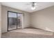 Bedroom featuring neutral walls, sliding door to balcony, ceiling fan and carpet at 16616 E Palisades Blvd # 109, Fountain Hills, AZ 85268