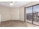 Bedroom featuring neutral walls, sliding door to balcony, ceiling fan and carpet at 16616 E Palisades Blvd # 109, Fountain Hills, AZ 85268
