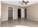 Spacious bedroom features a ceiling fan, neutral walls, and multiple doorways to other rooms at 16616 E Palisades Blvd # 109, Fountain Hills, AZ 85268