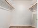 Walk-in closet features painted white walls and open shelving with two wooden clothing bars at 16616 E Palisades Blvd # 109, Fountain Hills, AZ 85268