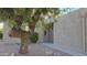 Inviting home exterior features a desert landscaped yard and a light-colored stucco facade, with a mature tree at the front at 16616 E Palisades Blvd # 109, Fountain Hills, AZ 85268