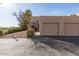 Beige stucco home with a two car garage and a desert landscaped yard at 16616 E Palisades Blvd # 109, Fountain Hills, AZ 85268