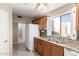 Kitchen area with granite countertops, brown wood cabinets and white appliances at 16616 E Palisades Blvd # 109, Fountain Hills, AZ 85268