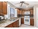 Kitchen with granite countertops, wood cabinets, and stainless steel sink at 16616 E Palisades Blvd # 109, Fountain Hills, AZ 85268