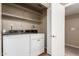 Laundry room featuring front loading machines, shelves, and a door at 16616 E Palisades Blvd # 109, Fountain Hills, AZ 85268