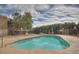 Community pool with deck chairs and tables surrounded by desert landscaping and an iron fence at 16616 E Palisades Blvd # 109, Fountain Hills, AZ 85268