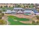 Aerial view of the clubhouse, pool, and golf course with mature trees and beautifully manicured landscapes at 17443 N Goldwater Dr, Surprise, AZ 85374