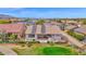 Aerial view of home with solar panels, patio, lush landscaping, and golf course frontage at 17443 N Goldwater Dr, Surprise, AZ 85374