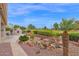 Manicured backyard with a water feature, desert landscaping, and grill at 17443 N Goldwater Dr, Surprise, AZ 85374
