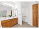 Bright bathroom featuring a double sink vanity, tiled floors, and walk-in closet at 17443 N Goldwater Dr, Surprise, AZ 85374