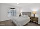 Cozy bedroom with soft carpet, decorative pillows, and plantation shutters for natural light at 17443 N Goldwater Dr, Surprise, AZ 85374