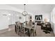 Bright dining room featuring a stylish chandelier and seating for six at 17443 N Goldwater Dr, Surprise, AZ 85374