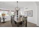 Bright dining room featuring a stylish chandelier and seating for six at 17443 N Goldwater Dr, Surprise, AZ 85374