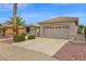 Single-story home with a neutral color scheme, desert landscaping, and two-car garage at 17443 N Goldwater Dr, Surprise, AZ 85374