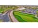 Expansive golf course near clubhouse and parking, surrounded by green landscapes and flowers at 17443 N Goldwater Dr, Surprise, AZ 85374