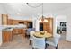 Open kitchen with oak cabinets, black appliances, granite counters and a round dining table at 17443 N Goldwater Dr, Surprise, AZ 85374