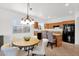 Cozy eat-in kitchen area with island, stainless steel refrigerator, and bright, natural light at 17443 N Goldwater Dr, Surprise, AZ 85374