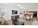 Open-concept kitchen with stainless steel appliances, breakfast bar, and adjacent dining area at 17443 N Goldwater Dr, Surprise, AZ 85374