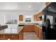 Well-lit kitchen with oak cabinets, granite countertops, stainless steel appliances, and a tile floor at 17443 N Goldwater Dr, Surprise, AZ 85374