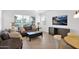 Comfortable living room with neutral colors, tile flooring, and large windows providing ample natural light at 17443 N Goldwater Dr, Surprise, AZ 85374